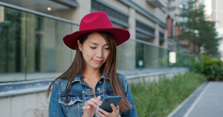 Woman wear hat and use of mobile phone at outdoor