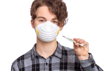 Concept of coronavirus quarantine. Happy Child wearing medical protective mask holding thermometer...