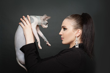 Elegant woman and cat in diamond on black background