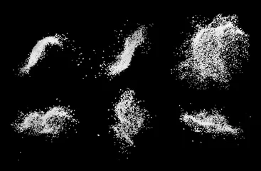 Foto op Aluminium Set of sea salt splash explosion isolated on black background close up, freeze motion © Vladyslav Bashutskyy