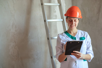 Interior designer in the apartment is making note for preparing renovation