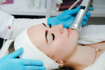 Cosmetologist making oxygen mesotherapy to a woman at the luxury beauty salon. Concept of a...