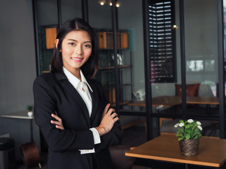asia business man woman standing cross arm and pointing,thumbs up,looking camera copy space