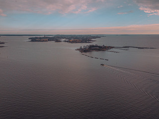 Helsinki islands. Scandinavian sea landscape. Beautiful sunset with reflection of clouds in the sea Aerial top down drone shot.