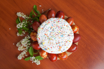 Easter symbols food - Easter cake and painted eggs. Easter orthodox sweet bread, kulich and colorful quail eggs. Holidays breakfast concept. Traditional orthodox christian easter food. Top view.