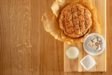 yeast for baking. Dry yeast, pressed yeast and homemade yeast (sourdough) on an oak table next to freshly baked bread.