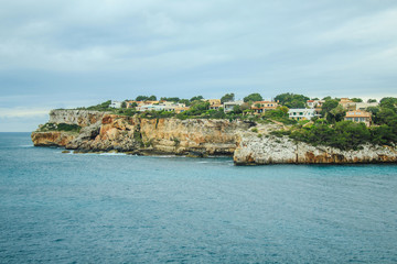 Fototapeta na wymiar picturesque rough coastline on a cloudy day near Santanyi, Mallorca, Spain