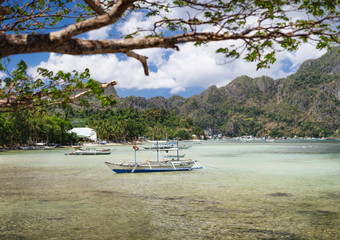 El Nido bay in low tide. Bangka fishing in the shallow water in low tide. Palawan, Philippines
