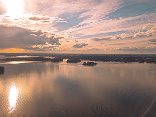 Helsinki islands. Scandinavian sea landscape. Beautiful sunset with reflection of clouds in the sea Aerial top down drone shot.