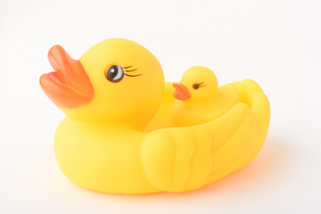 Yellow inflatable duck toy with a little duckling. Isolated on a white background.