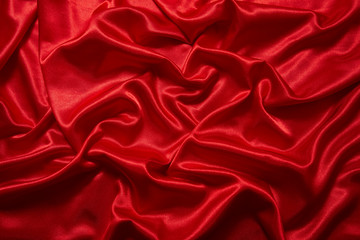 Obraz premium Luxury red satin smooth fabric background for celebration, ceremony, event invitation card or advertising poster