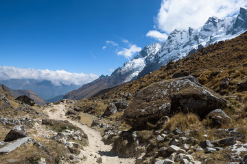 Rocky paths and green valleys surrounded by snowcapped mountains on the Salkantay Trek, Peru