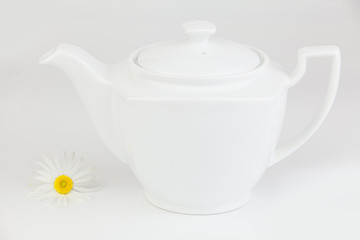 Green Chinese tea in teapots on white background