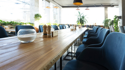 Interior of comfortable cafe with dining places with blue armchairs