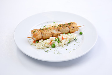 chicken kebab with rice and vegetables on the white background