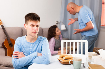 Upset teenager suffering from mom and dad arguing