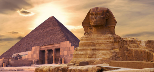 Sphinx against the backdrop of the great Egyptian pyramids. Africa, Giza Plateau. - obrazy, fototapety, plakaty