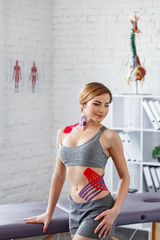 Weight loss concept.Kinesiology taping.Therapist applying kinesiology tape to patient belly.Anti-cellulite procedure for slim tummy.Fat lose,cellulite removal, sport physical therapy,recovery concept.