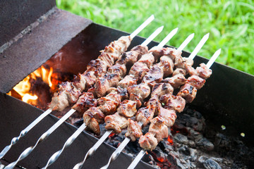 Barbecue with grilled meat and onions on chargrill. Outside location