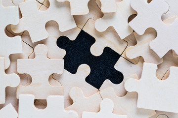 wooden jigsaw puzzle pieces on black background