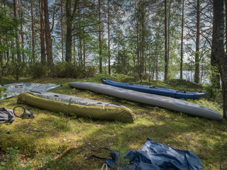 Kayaks and boats are drying. Rest point on island. Active extreme holidays in Karelia. Water tourism