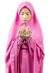 Asian Muslim woman in a veil standing while raised hands and praying