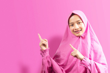 Asian Muslim woman in a veil pointing something