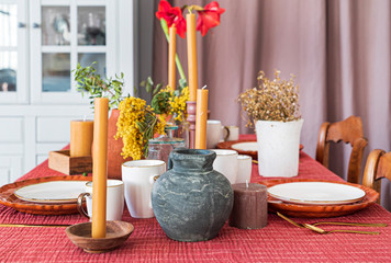candles and vases with plants on the table