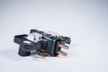 Automotive relay voltage regulator voltage regulator. New electric car spare parts on gray...