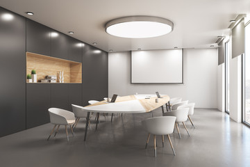 Modern conference room with blank poster on wall.