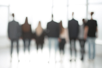 rear view. blurry image of a business team looking out the window