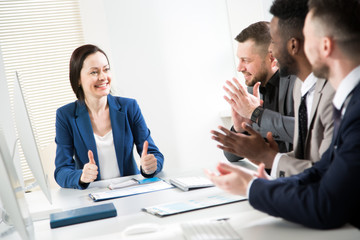 Business people clapping hands at business seminar.
