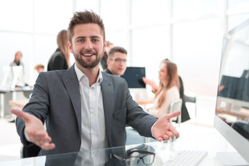 close up. friendly businessman sitting at an office Desk.