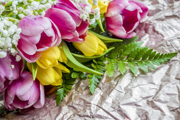 pink and yellow tulips bouquet on paper background