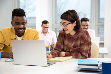 Multy-ethnic group of young business people working with computer at office