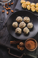 Delicious homemade chocolate chip cookies balls on a black wooden background.