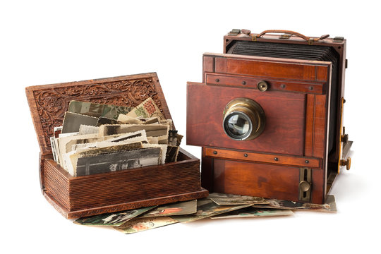 Vintage film photo-camera and old family photos.