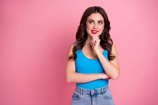 Photo of attractive lady good mood look up empty space bite lips have tricky sly idea minded wear casual blue tank-top denim skirt isolated pink bright color background