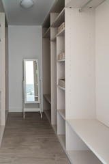 Fototapeta na wymiar Modern empty wooden wardrobe with mirror. Walk in closet interior design