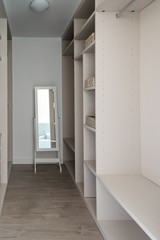 Modern empty wooden wardrobe with mirror. Walk in closet interior design