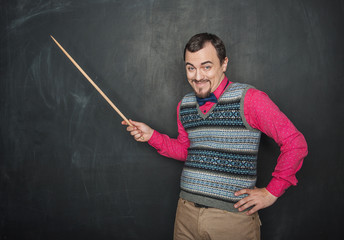 Funny giggle teacher man with pointer on blackboard