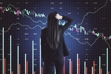 Pencive businesswoman looking on glowing stock analytics