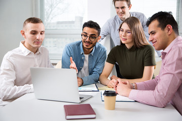 Multy-ethnic group of creative business people working with computer at office