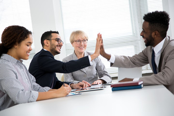 Happy overjoyed professionals multy-ethnic group rejoice victory