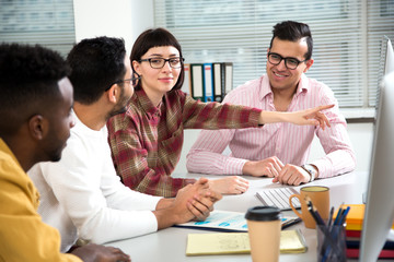 Multy-ethnic group of creative business people working with computer at office