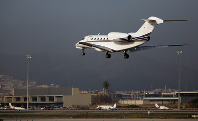Fototapeta na wymiar Private jet landing at Barcelona airport