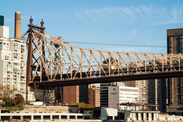 Old metal bridge with skyscrapers and industrial towers