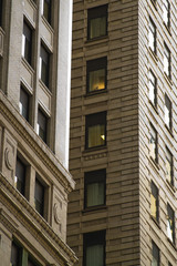 Brick building with illuminated window in Manhattan