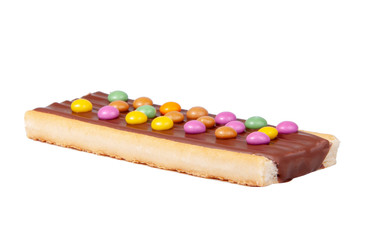 Chocolate bar snack with colorful drops or dragee isolated on the white