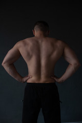 Fototapeta na wymiar athletic guy strains his back